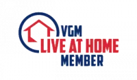 VGM Live at Home Member logo featuring a red house icon inside a blue circle, with VGM Live at Home Member written in bold red and blue letters.